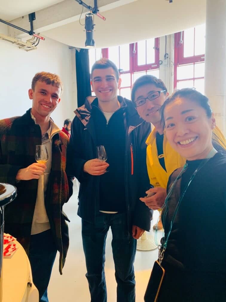 Jack and Yiannis with fellow tasters at the salon, glasses in hand and all smiles