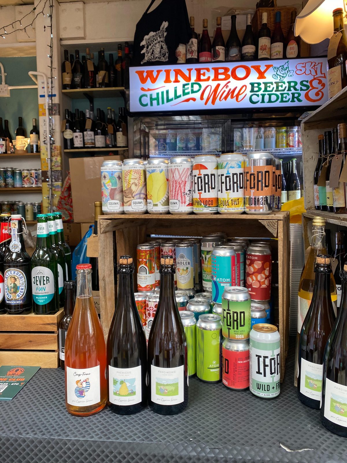The three Cidermugs cuvées by Cyprien Lireux (Coup-Franc, Prémices 2024 and Parcimonie 2024) on display at Wineboy Stockport beneath a 'Wineboy SK1 Chilled Wine Beers and Cider' sign, alongside an array of independent beers and natural wines
