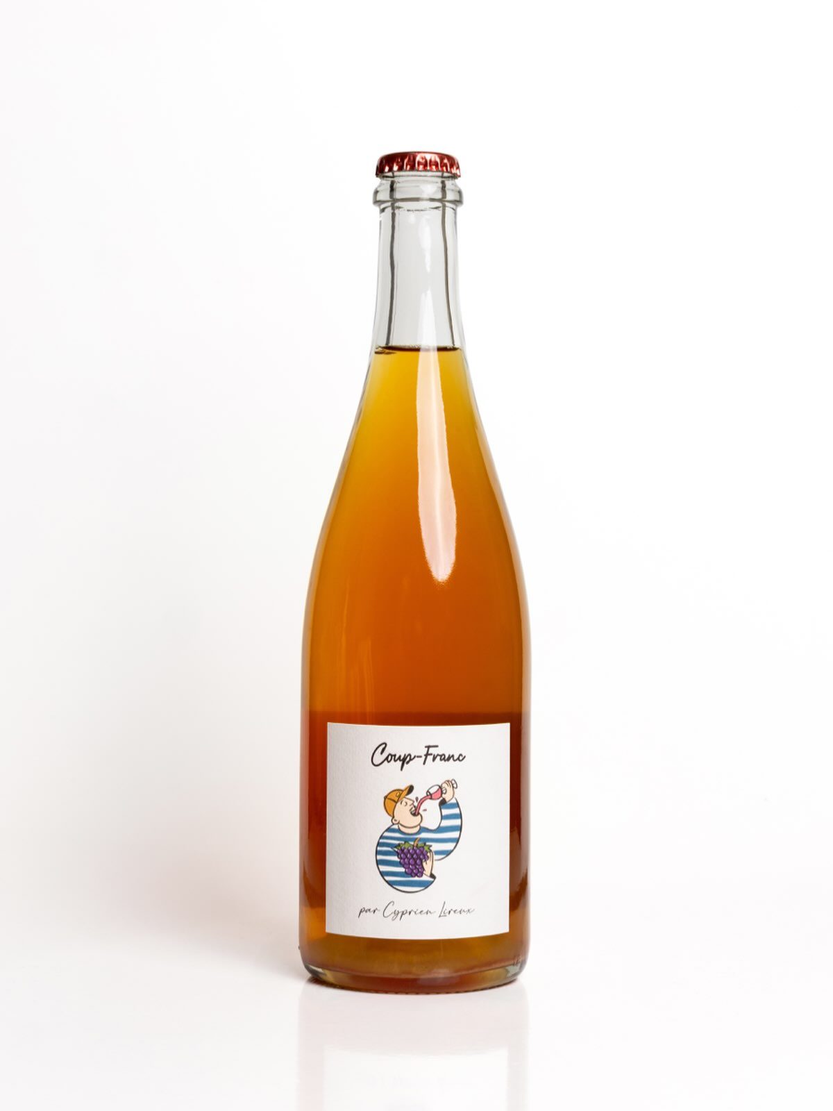 A studio shot of a bottle of Coup-Franc, its hazy amber colour glowing against a plain white background